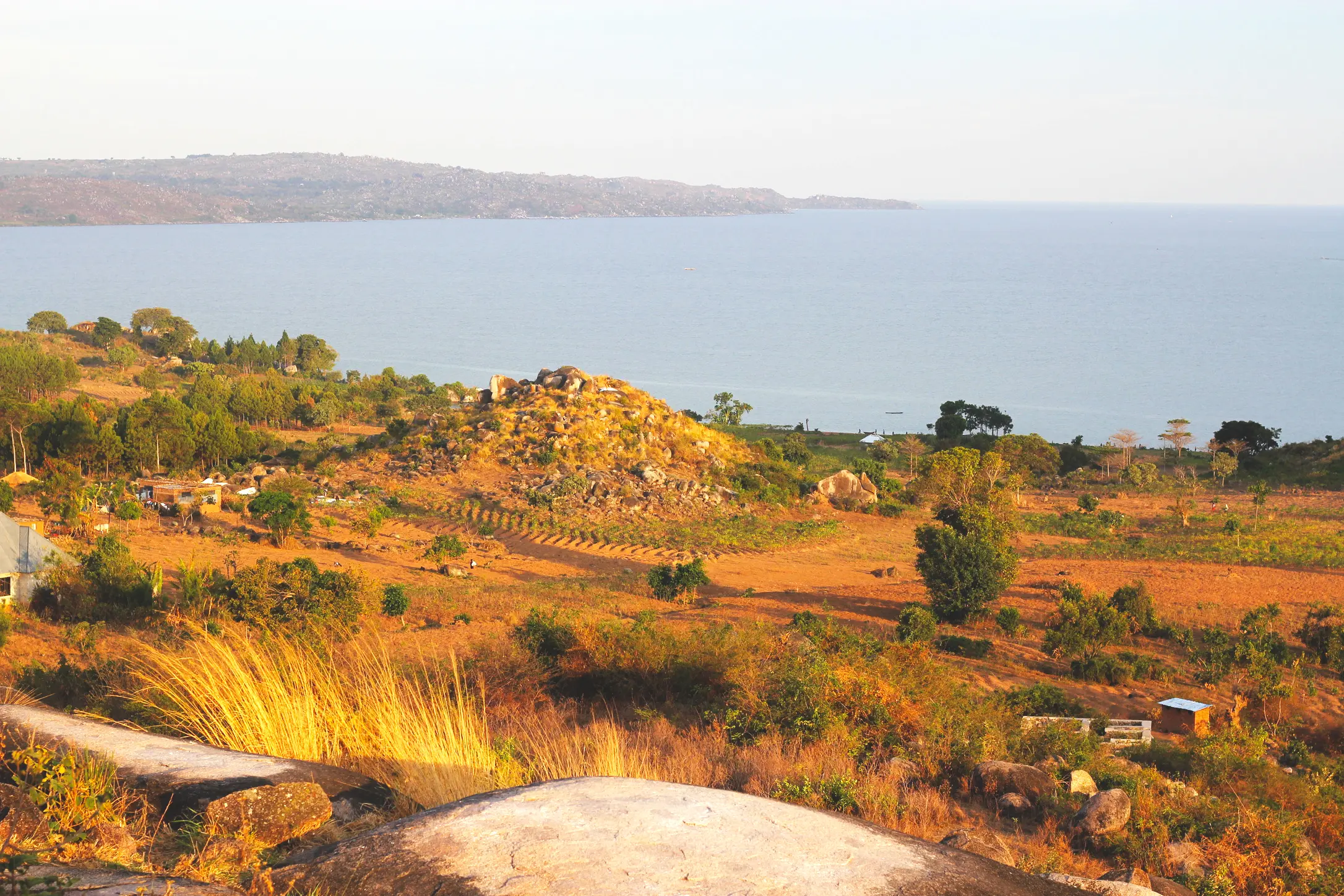 Coastal landscape with hillside and distant water.