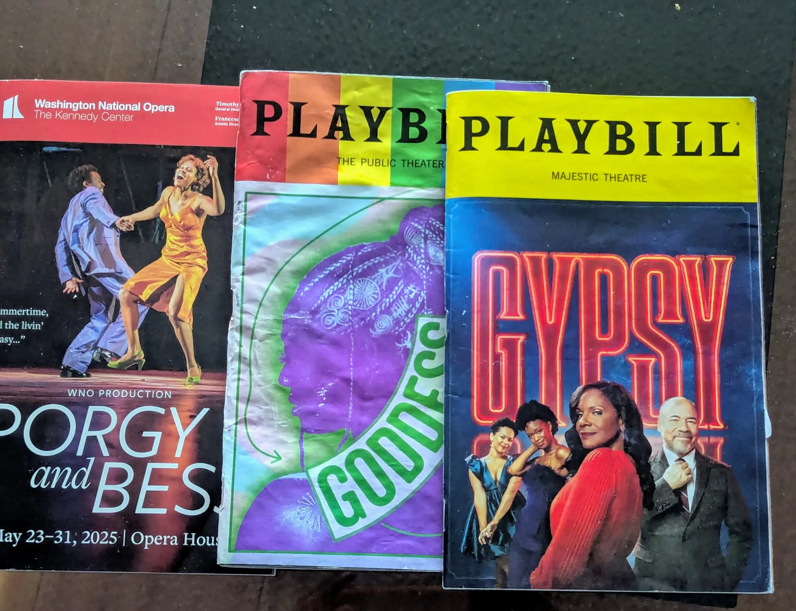 Three colorful theater playbills on display.