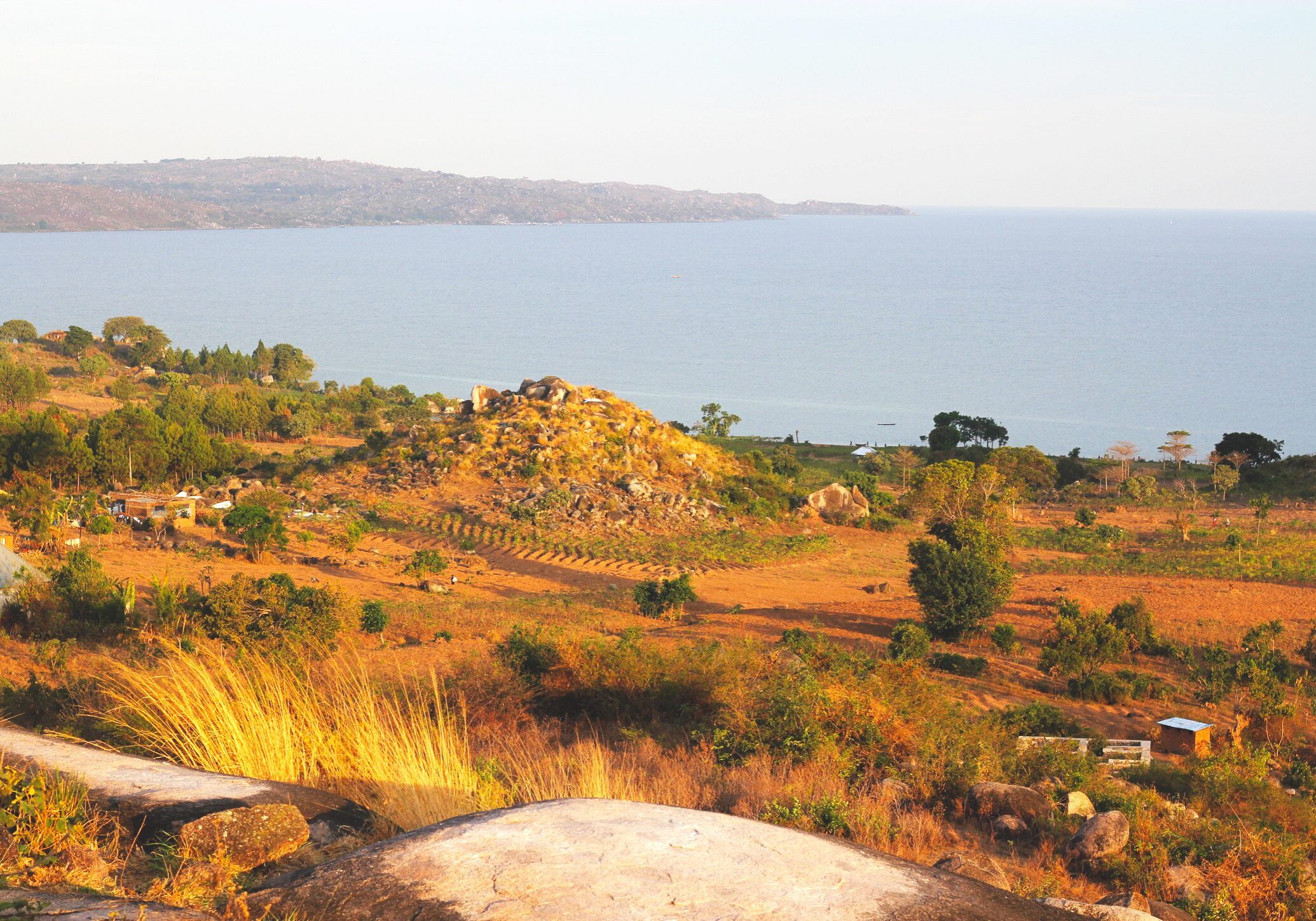 Coastal landscape with hillside and distant water.