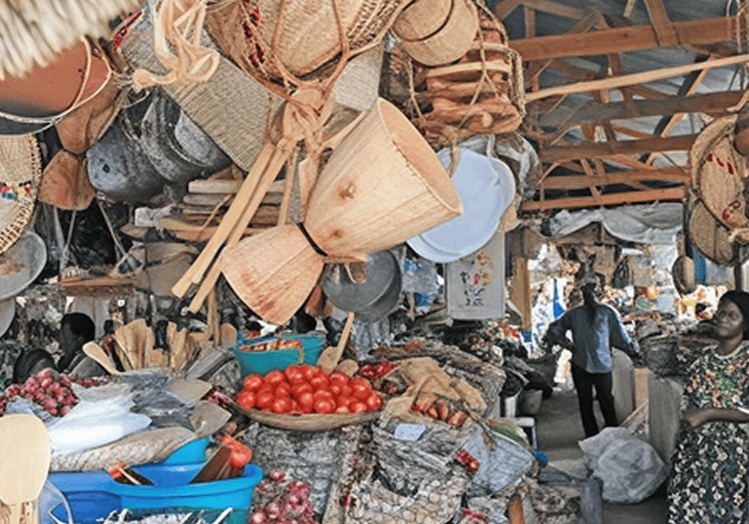 Bustling market with baskets and produce displayed.